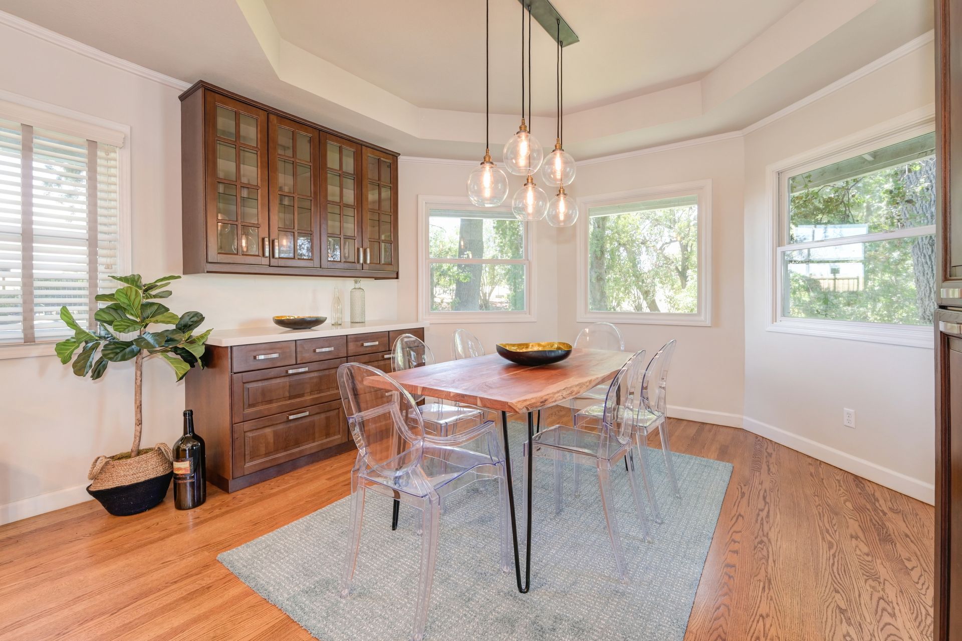 Bright dining area with table, chairs, and pendant lights. Explore homes for sale in East Sacramento, CA with Rich Cazneaux.