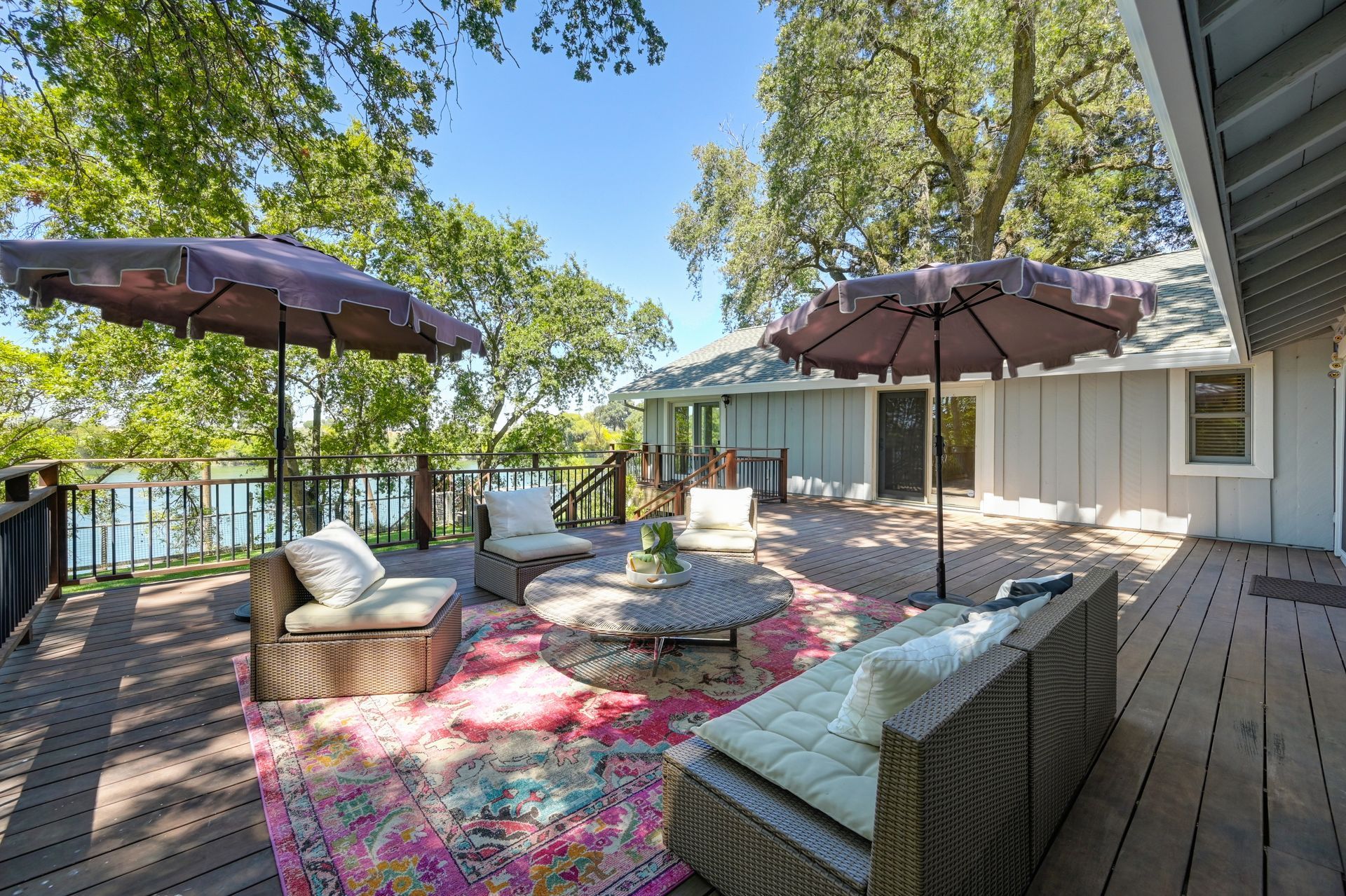 Large deck with umbrellas, seating, and views. Explore homes for sale in East Sacramento, CA, with Rich Cazneaux.