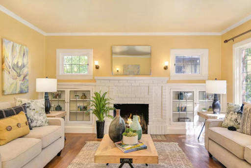 A living room with two couches , a coffee table and a fireplace.