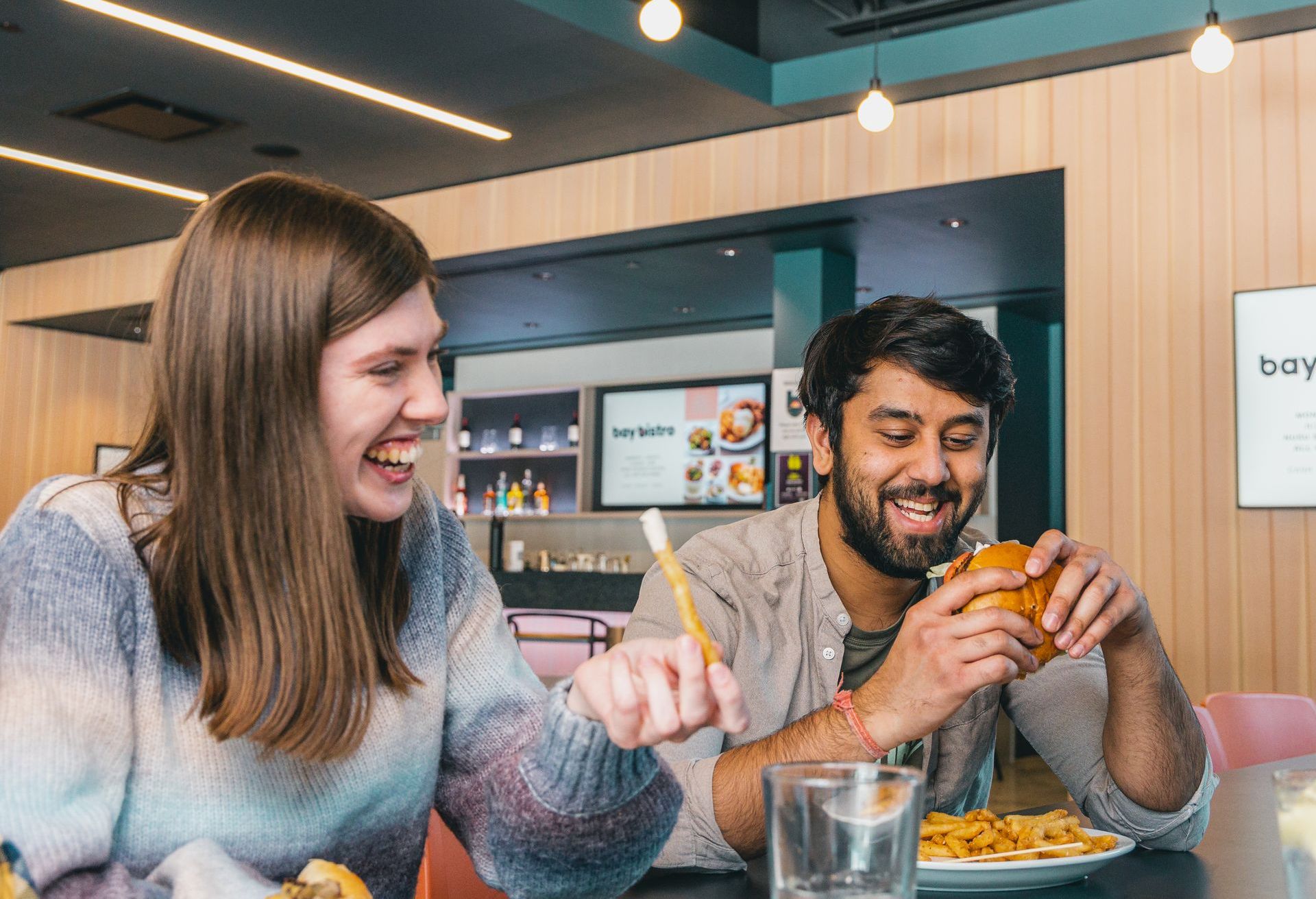 students eating and laughing at Bay Bistro