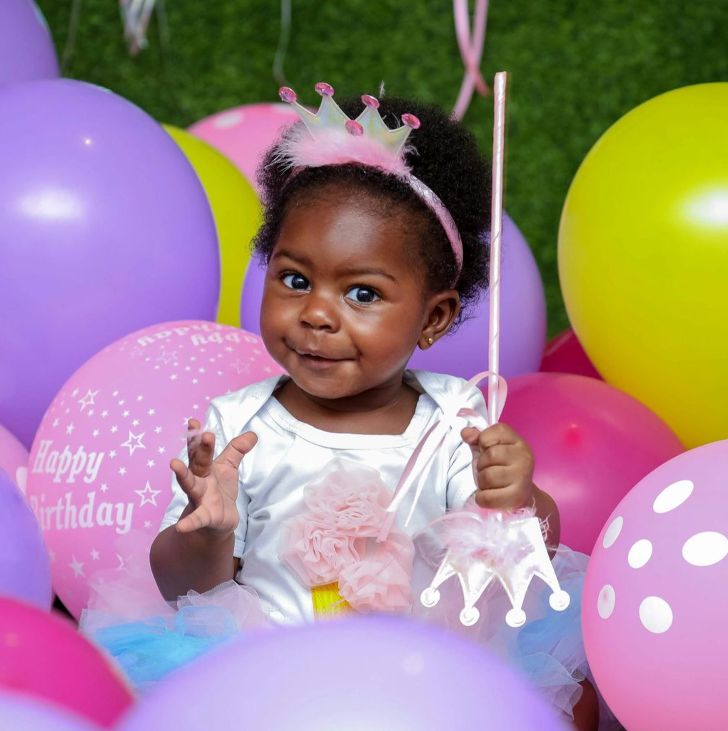 Girl smiling while playing with colorful building blocks.