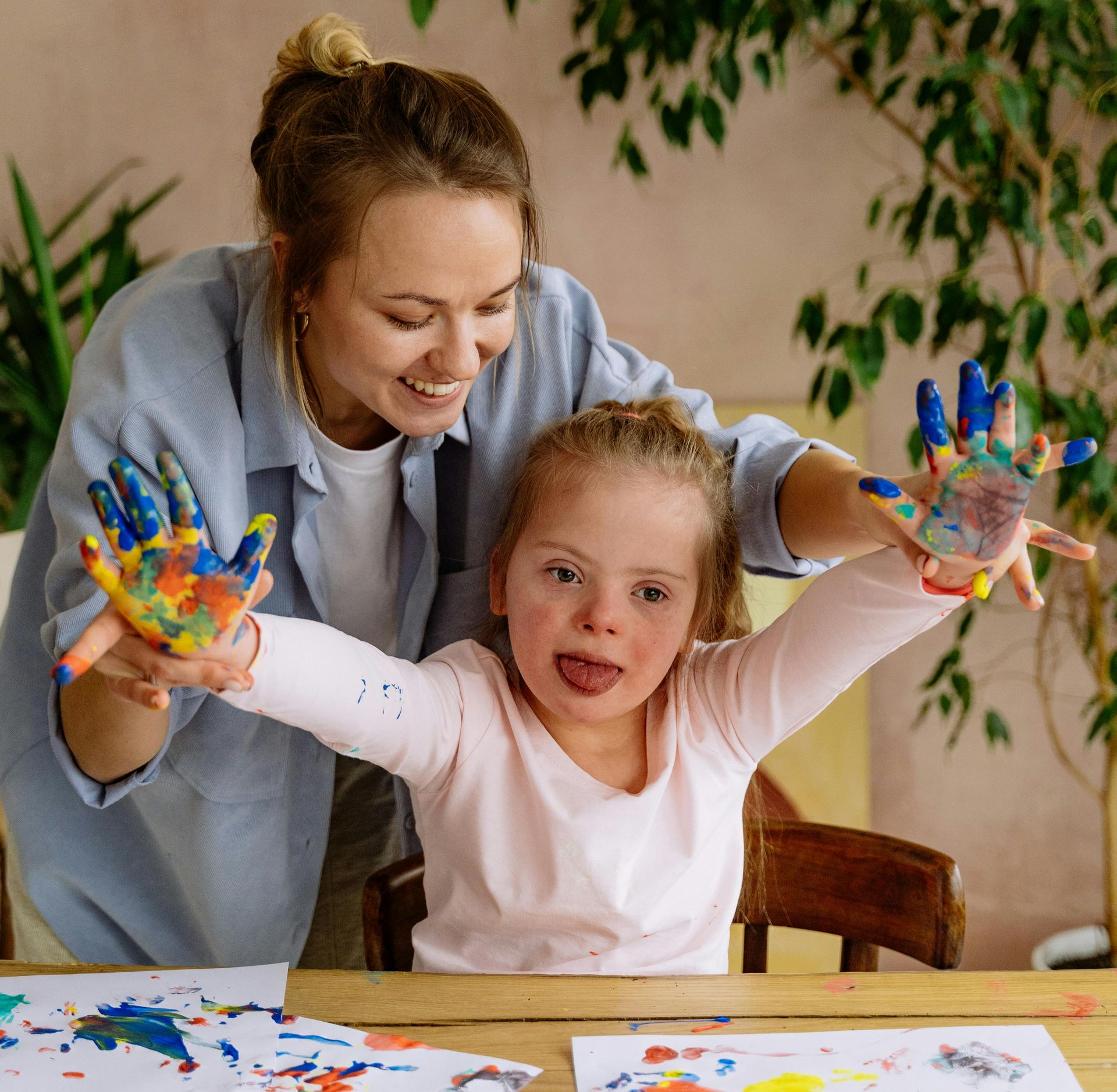 Smiling child with bandage on head and nose, wearing a hospital wristband.