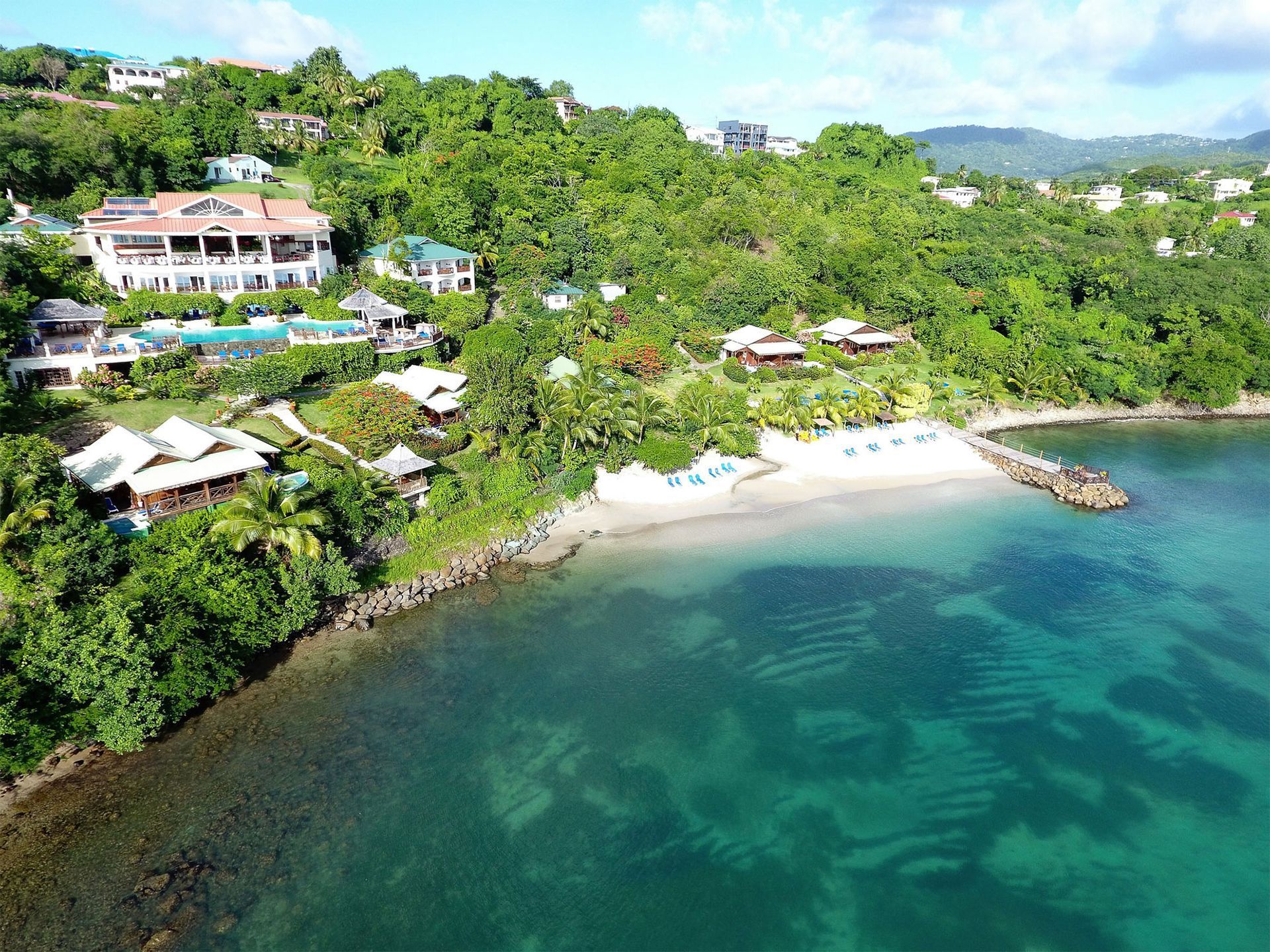 View of Calabash Cove from the air showing beach and azure sea