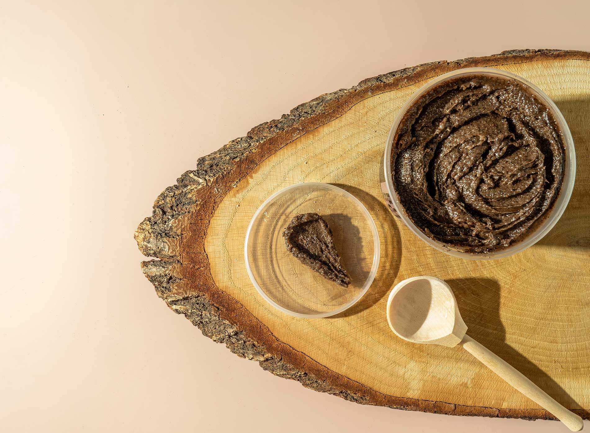 Picture of chocolate scrub preparation sitting on a tree bark platter
