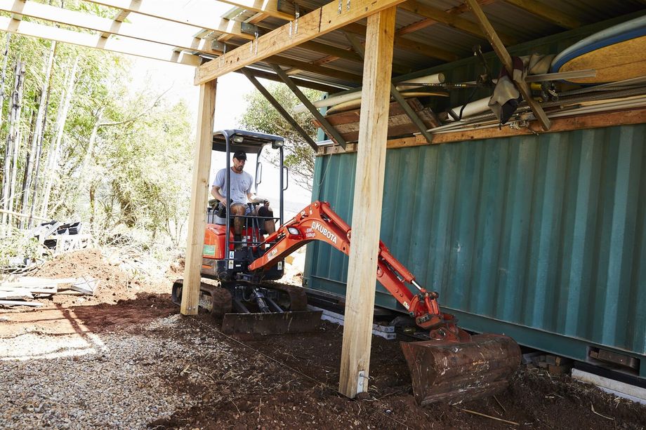 Landscaper Clearing Dirt Beneath A Shaded Area — Hinterland Property Services in Coopers Shoot, NSW