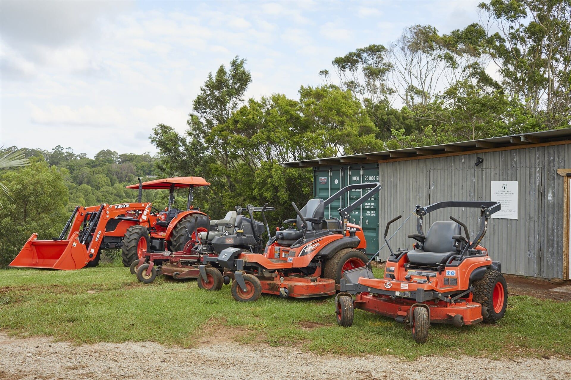 Ride-on Lawn Mowers Parked in a Row — Hinterland Property Services in Coopers Shoot, NSW