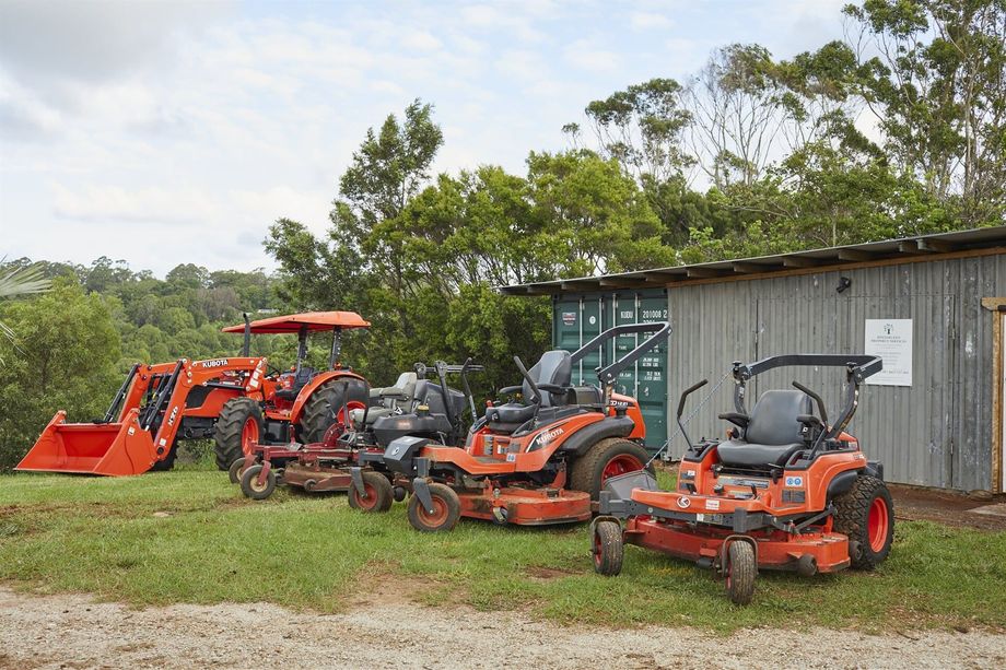 Landscaping Machinery Parked Outside a Shed — Hinterland Property Services in Coopers Shoot, NSW