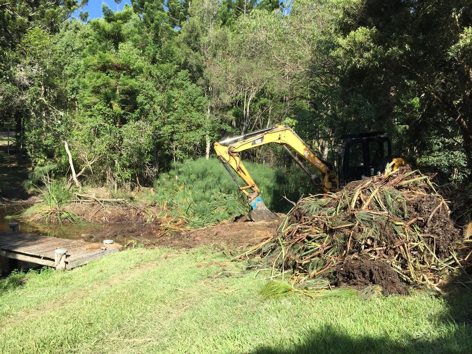 Worker Clearing Land With an Excavator — Hinterland Property Services in Coopers Shoot, NSW