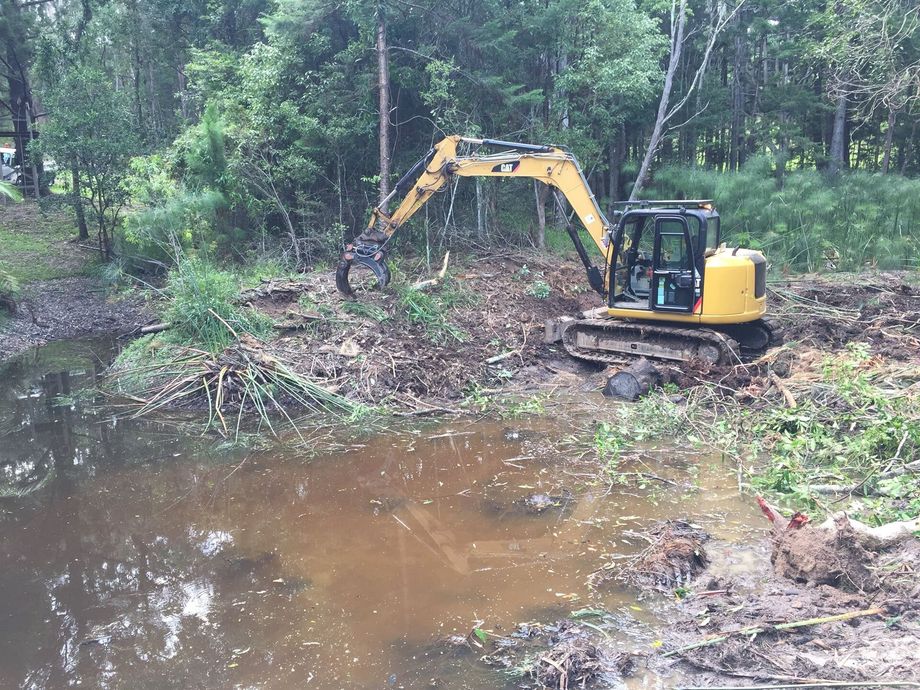 Excavator Being Used To Clear A Creek Bed — Hinterland Property Services in Coopers Shoot, NSW