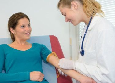 smiling doctor holding patient's arm 