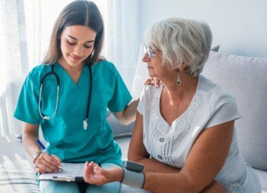 Nurse sitting with patient 