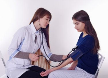 medical assistant measuring blood pressure