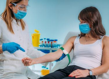 nurse holding patient's arm 