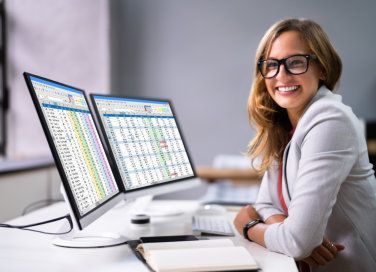 happy woman next to computer screen