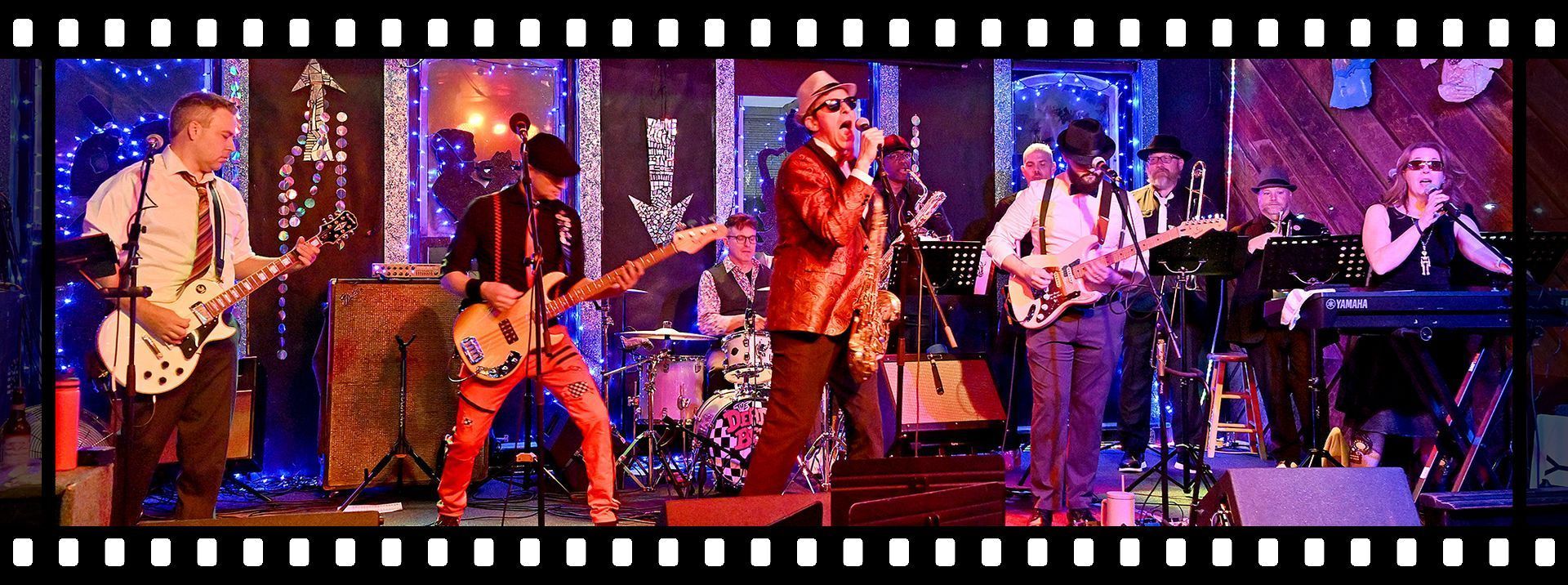 A group of men are playing guitars on a stage