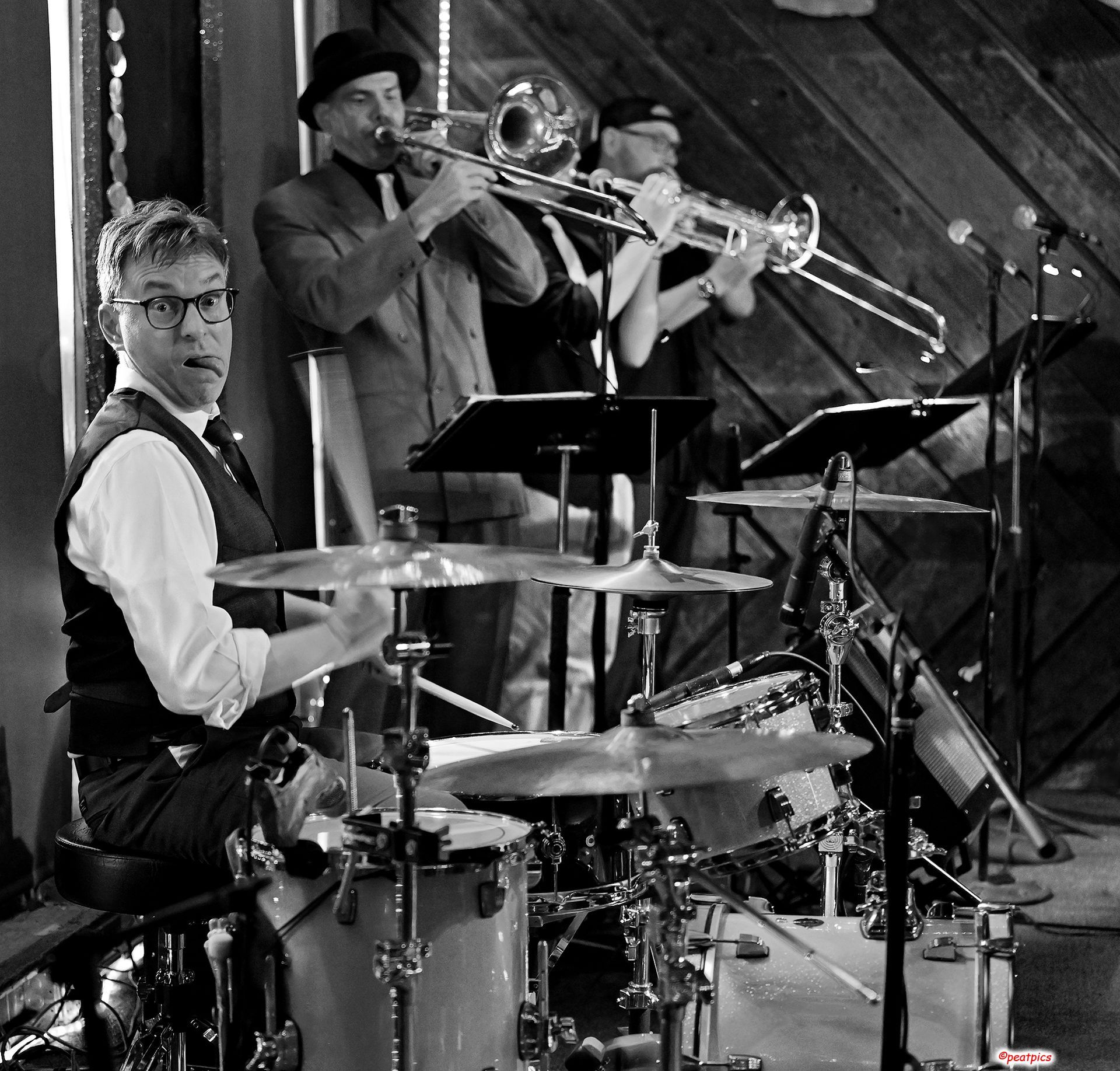 A man is playing a trombone in a band