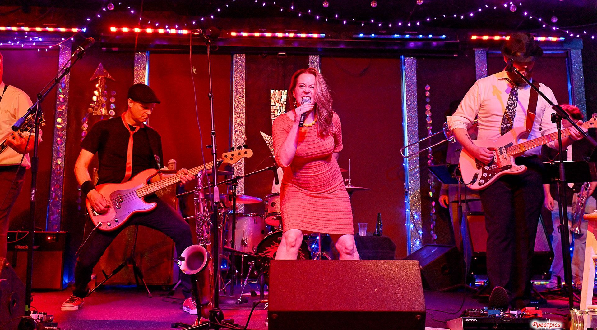 A group of people are playing instruments on a stage.