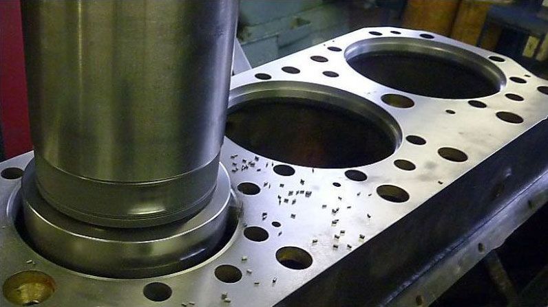 a close up of a metal piece with holes in it