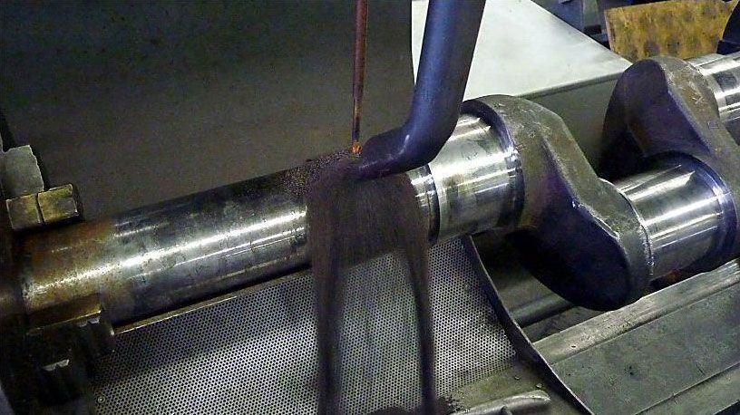 a machine is cutting a piece of metal in a factory