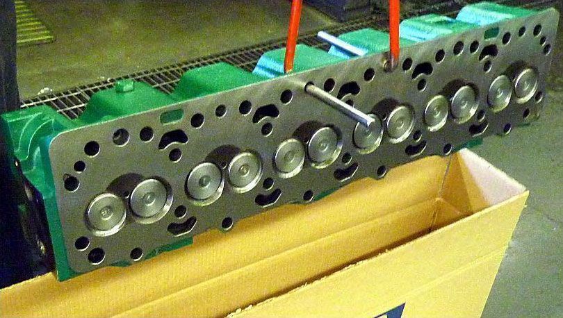 a cylinder head is sitting on top of a cardboard box