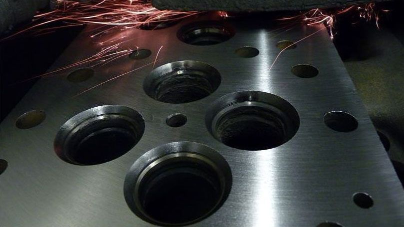 a close up of a metal surface with holes in it