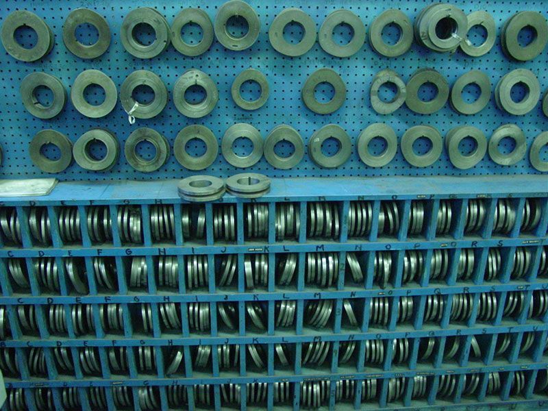 a bunch of rings are lined up on a wall