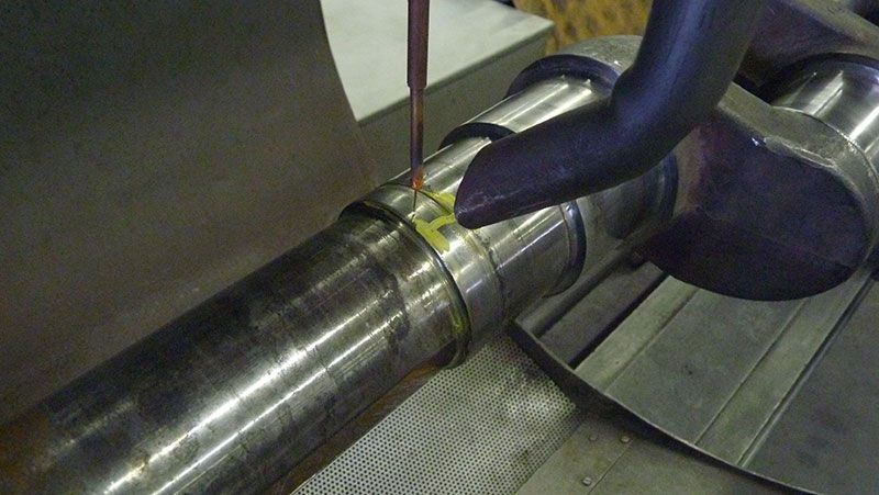 A specialist at our engine machine shop in Edmonton working on a crankshaft.