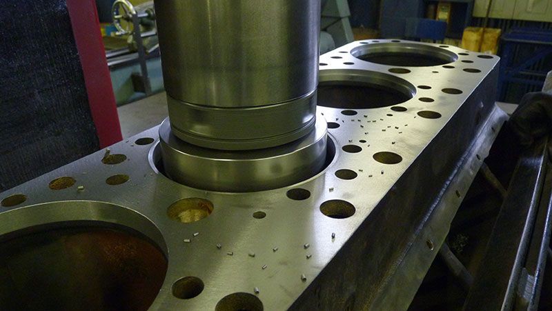 a piece of metal with holes in it is sitting on a table .