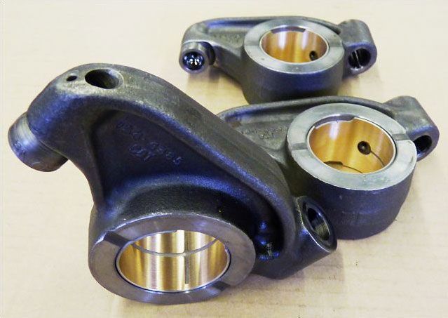 a pair of metal pieces with holes in them on a table