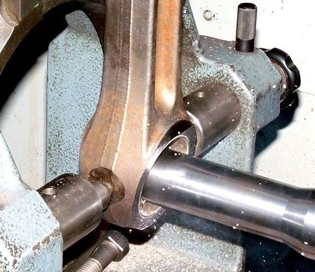 a piece of metal is being worked on by a machine