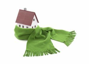 A small house is wrapped in a green scarf.