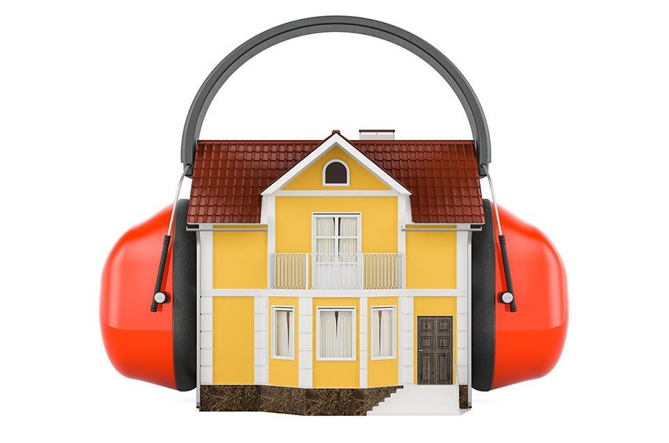 A yellow house is surrounded by ear muffs on a white background.