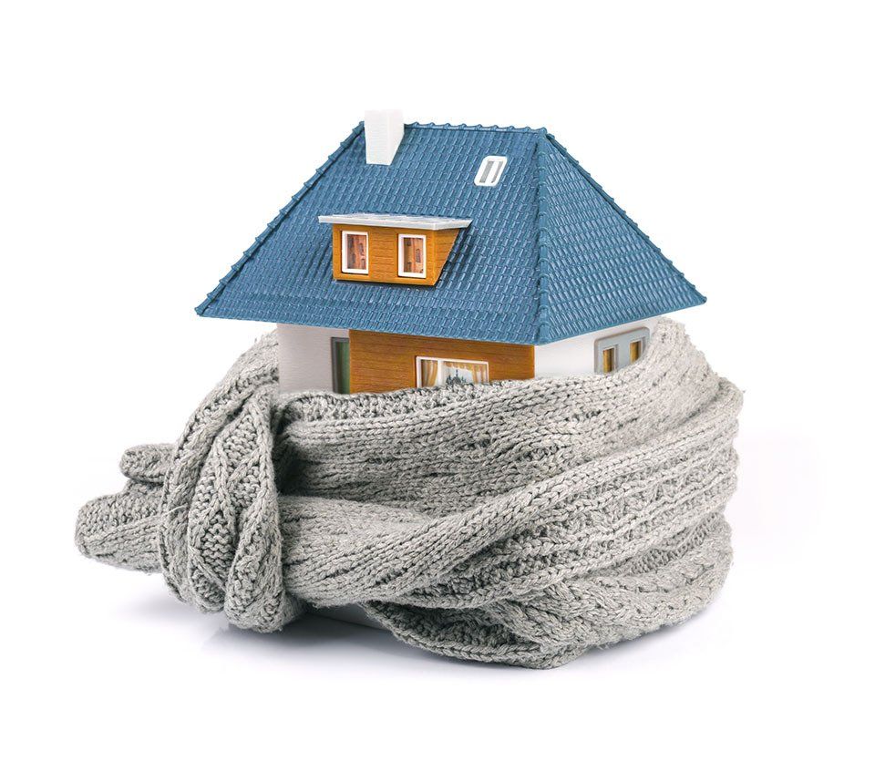 A model house wrapped in a scarf on a white background.