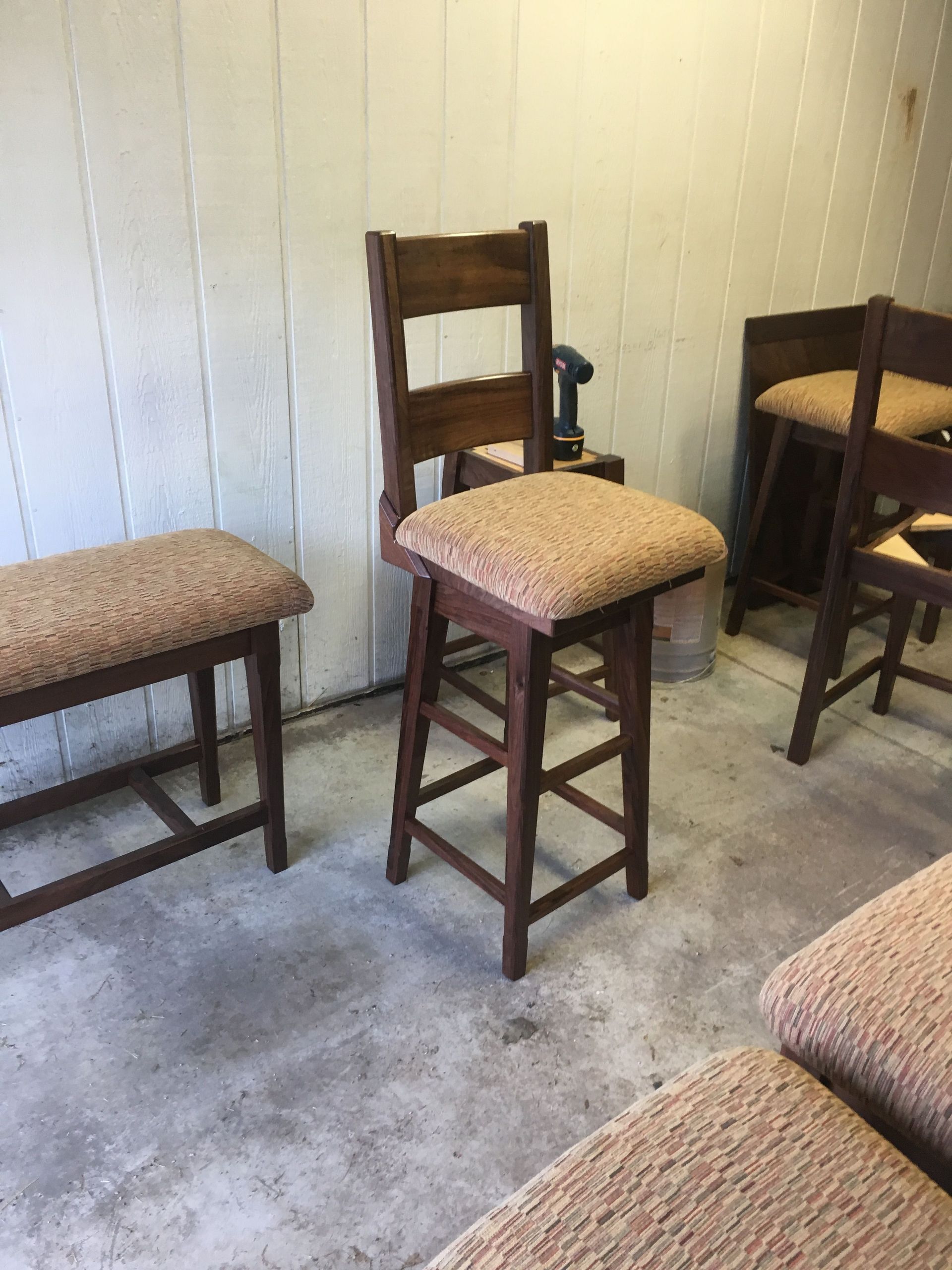 A group of chairs and benches are sitting in a room.