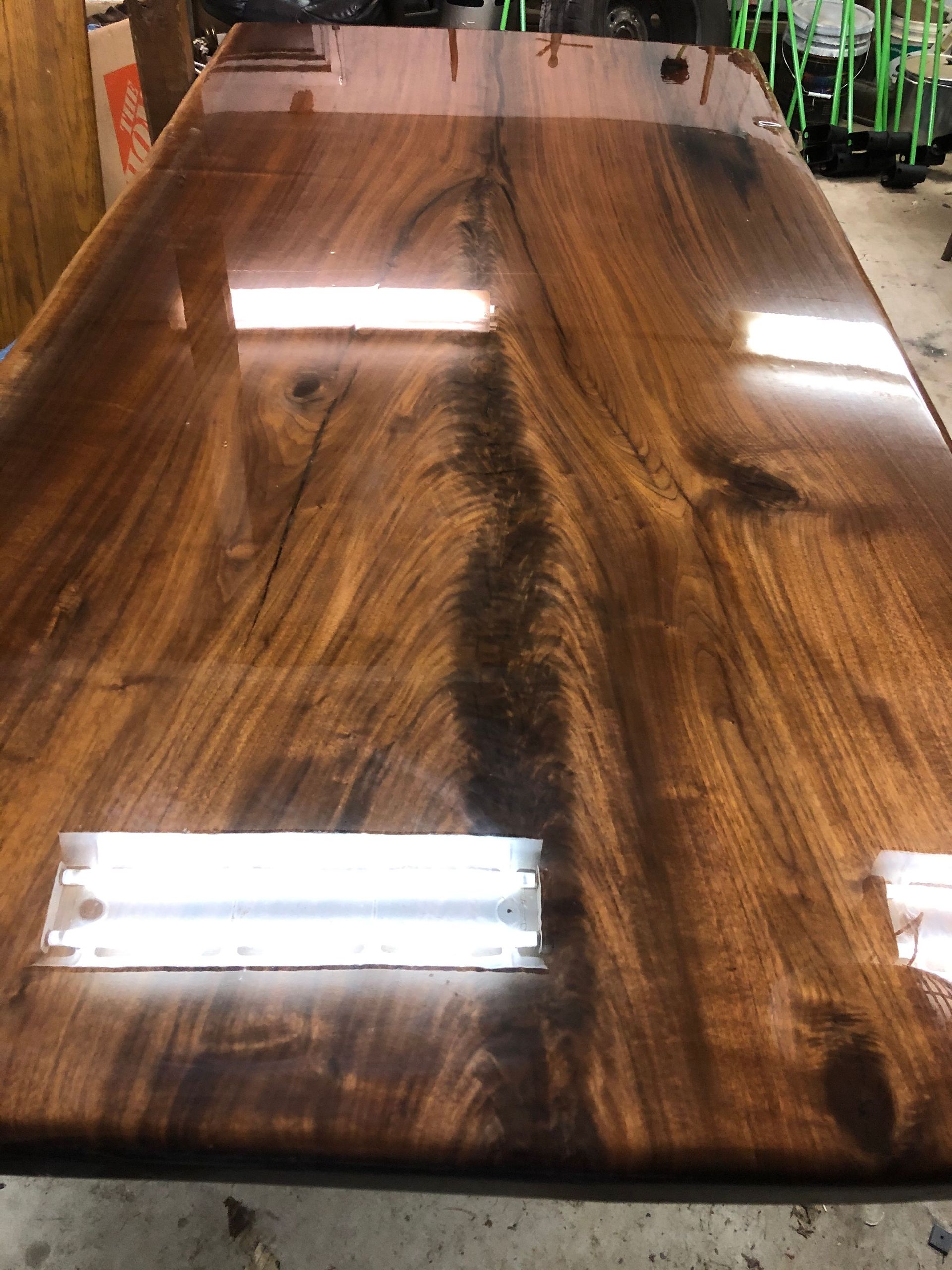 A wooden table with a shiny finish is sitting in a room.