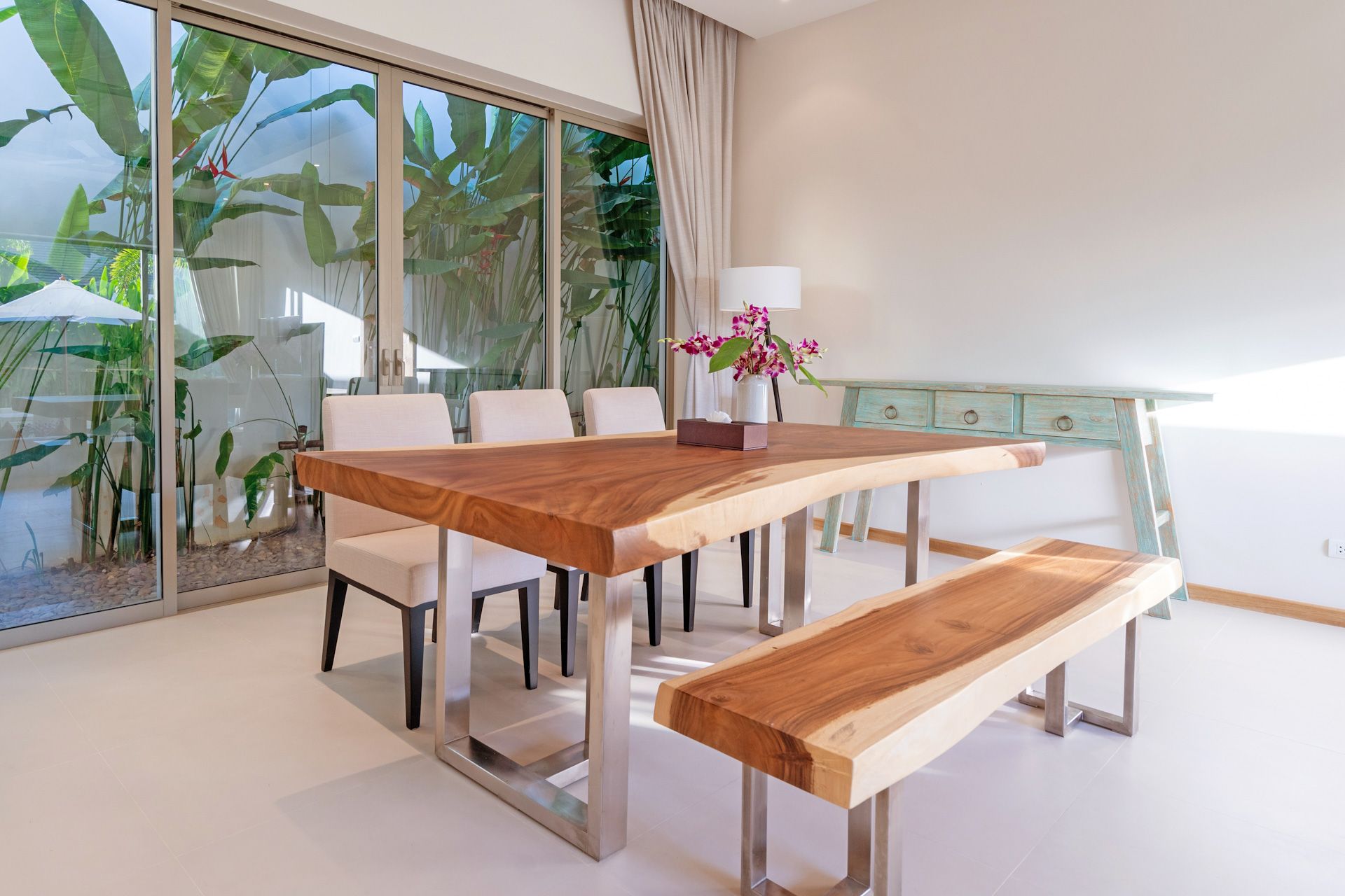 A wooden table and chairs are sitting on a sidewalk