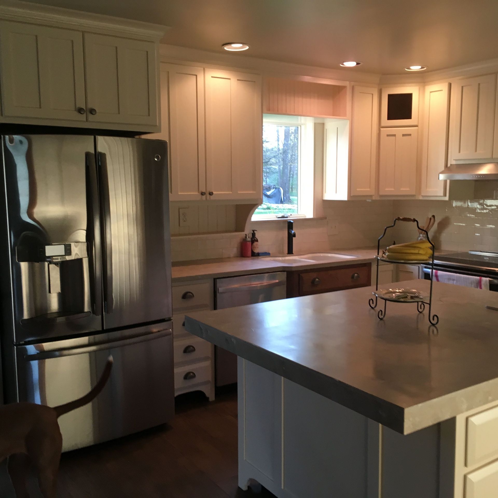 A kitchen with stainless steel appliances and white cabinets