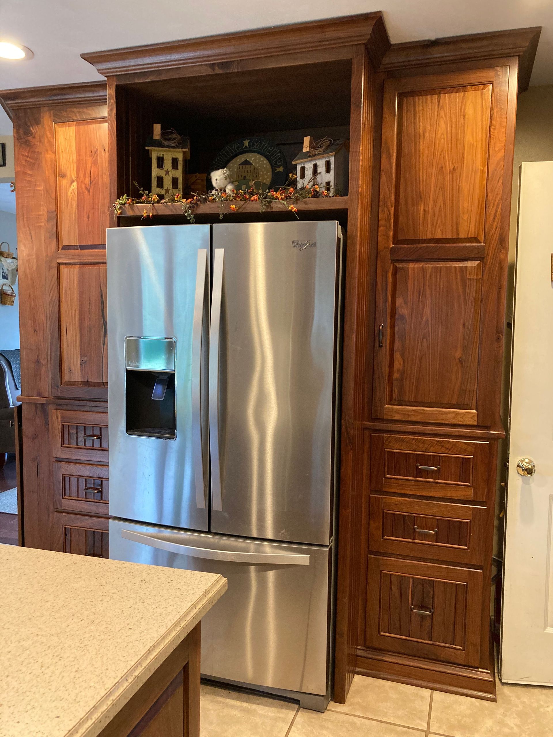 A kitchen with stainless steel appliances and wooden cabinets.