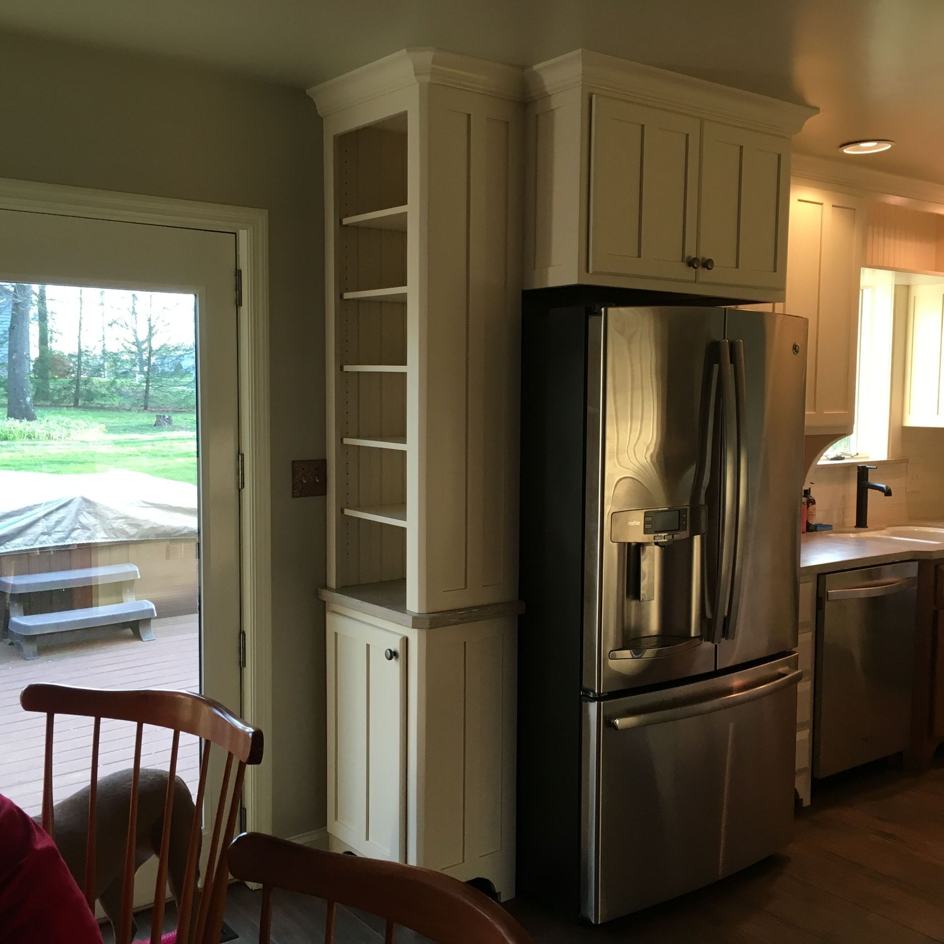 A kitchen with stainless steel appliances and white cabinets