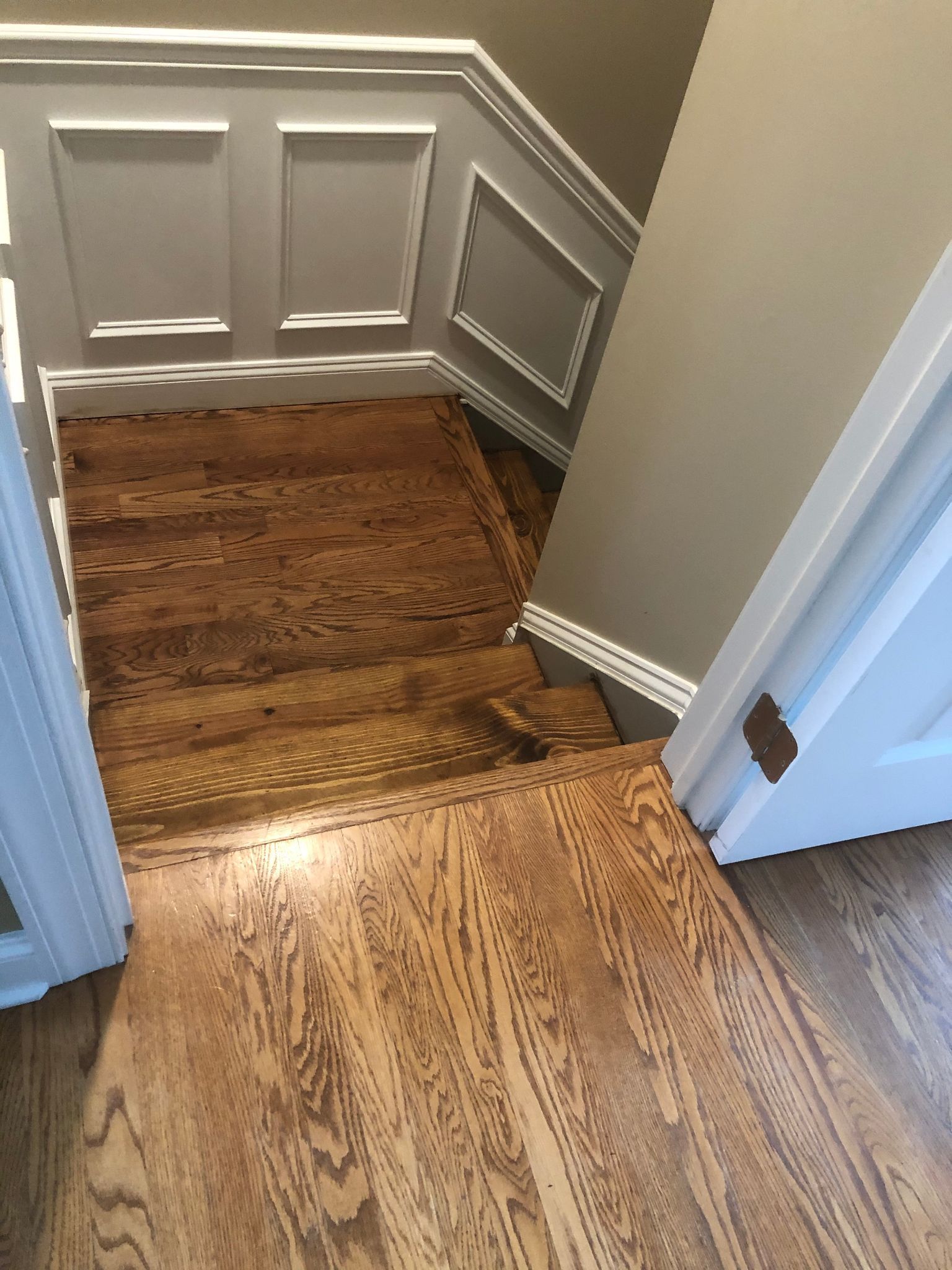 A wooden staircase leading up to the second floor of a house.