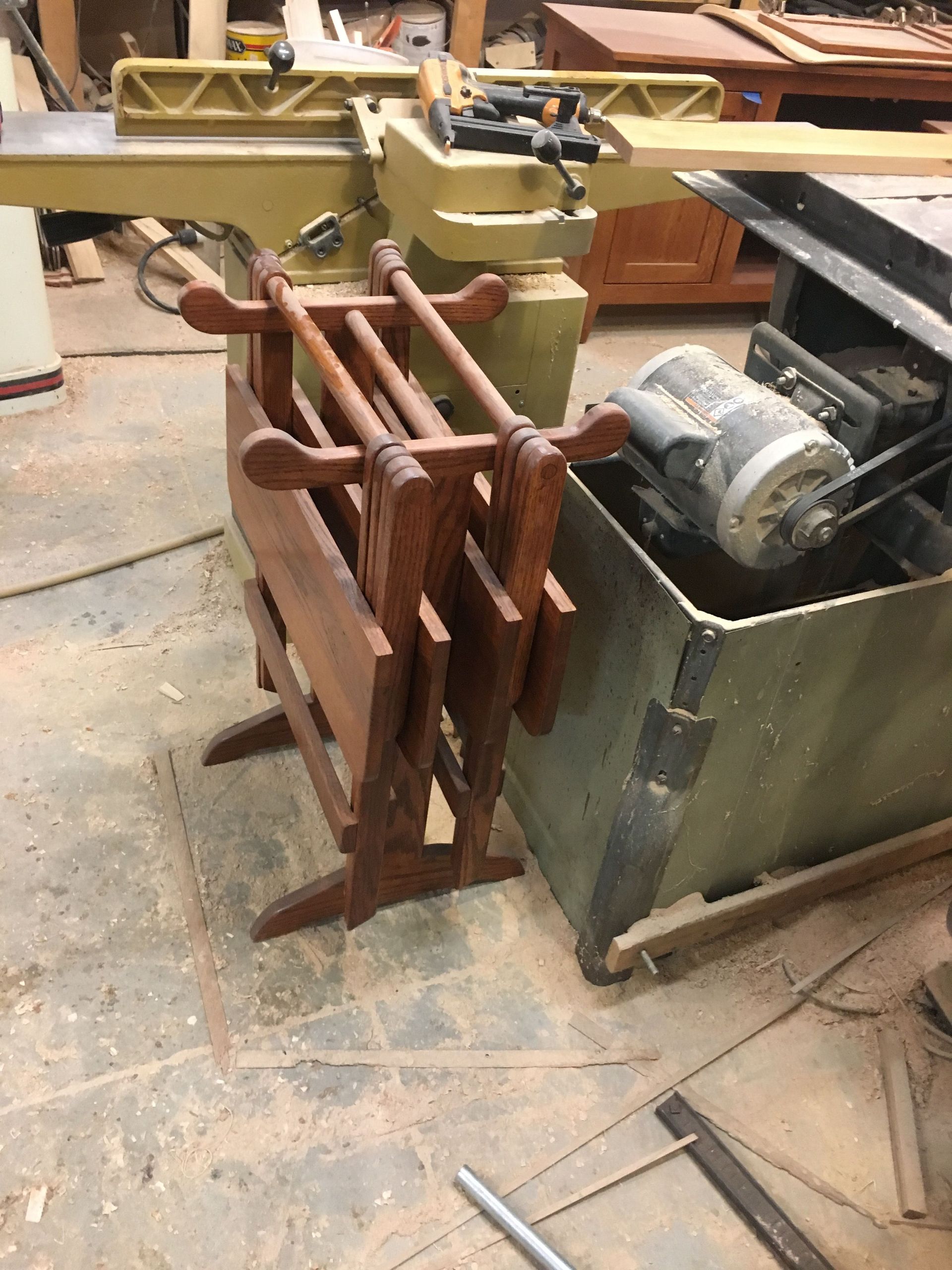A wooden table is sitting next to a machine in a workshop.