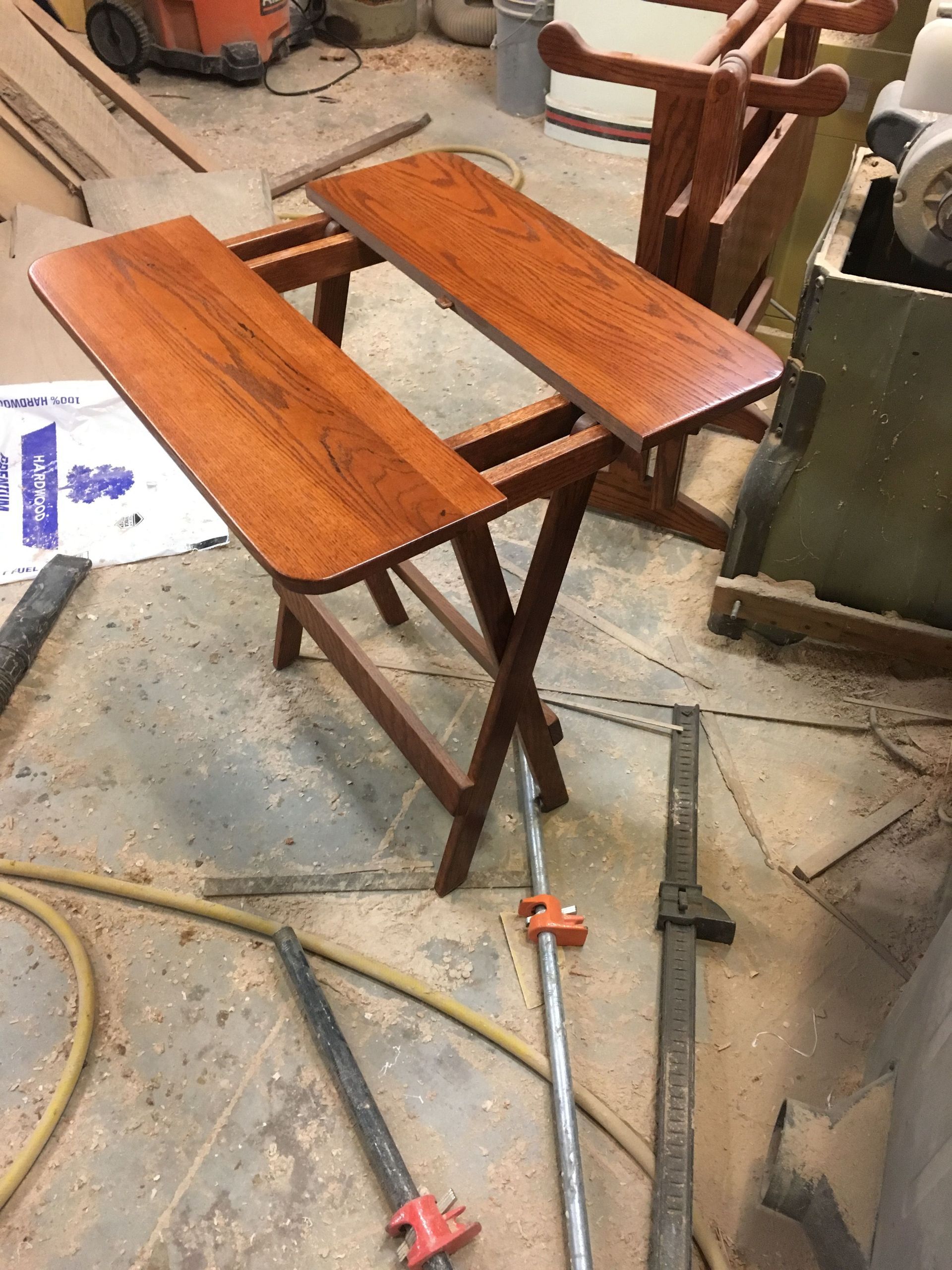 A wooden table is sitting on top of a wooden floor in a workshop.