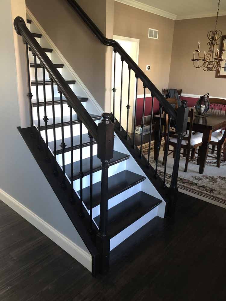 A black and white staircase in a dining room
