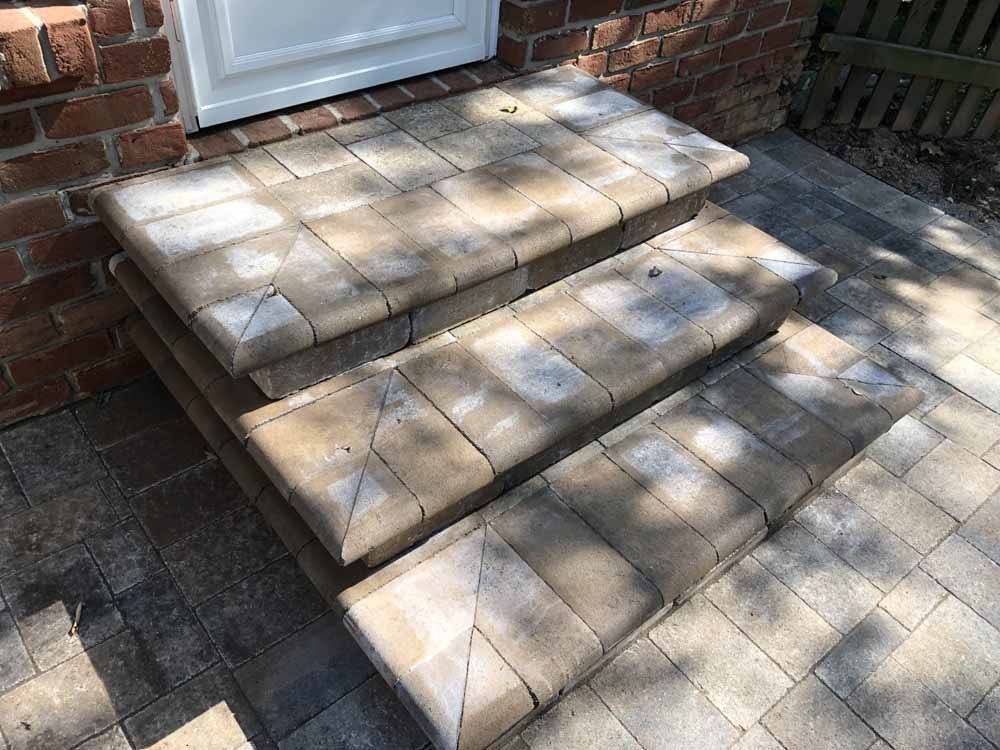A set of brick steps leading up to a brick door.