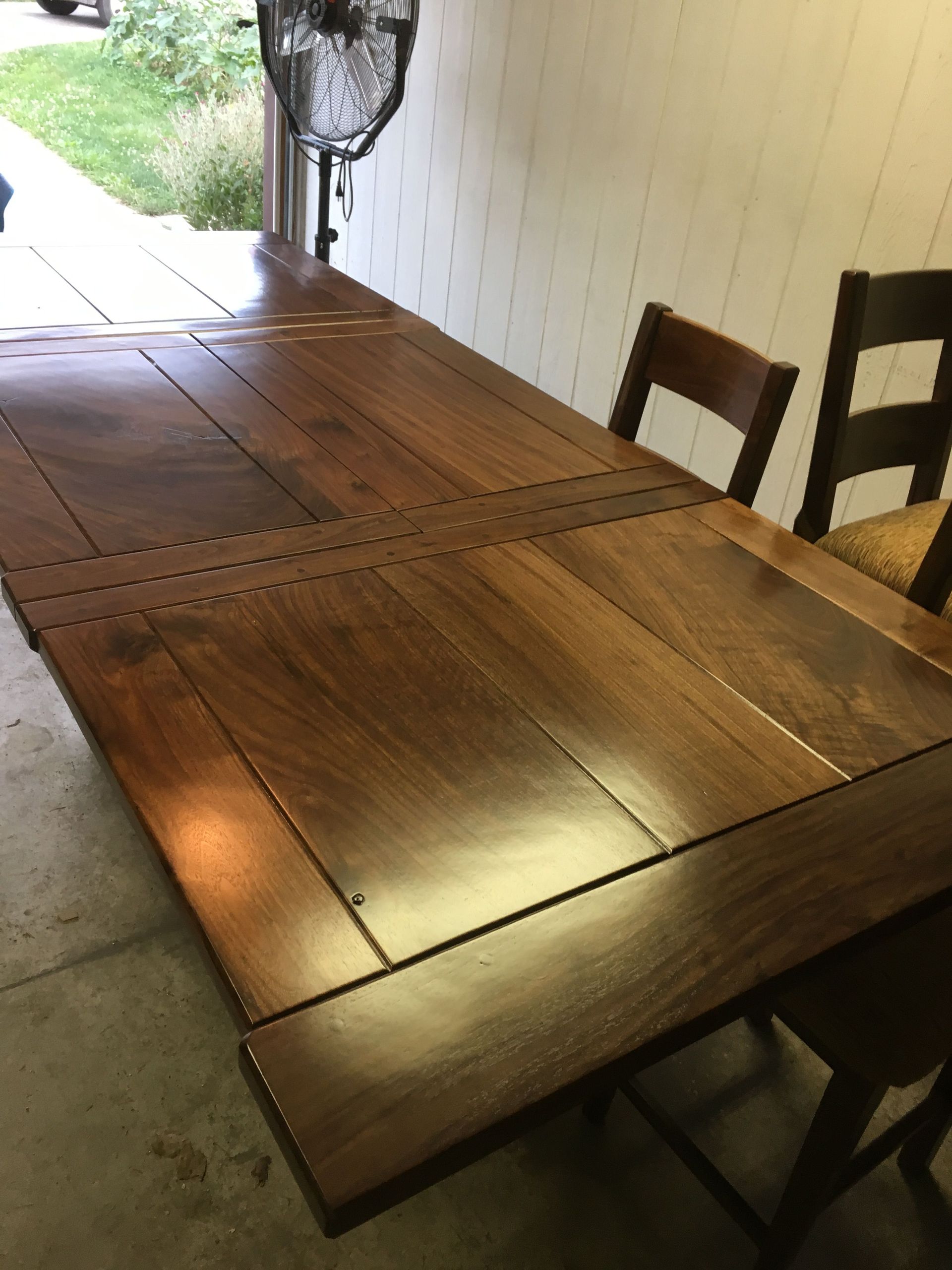 A wooden table and chairs in a garage