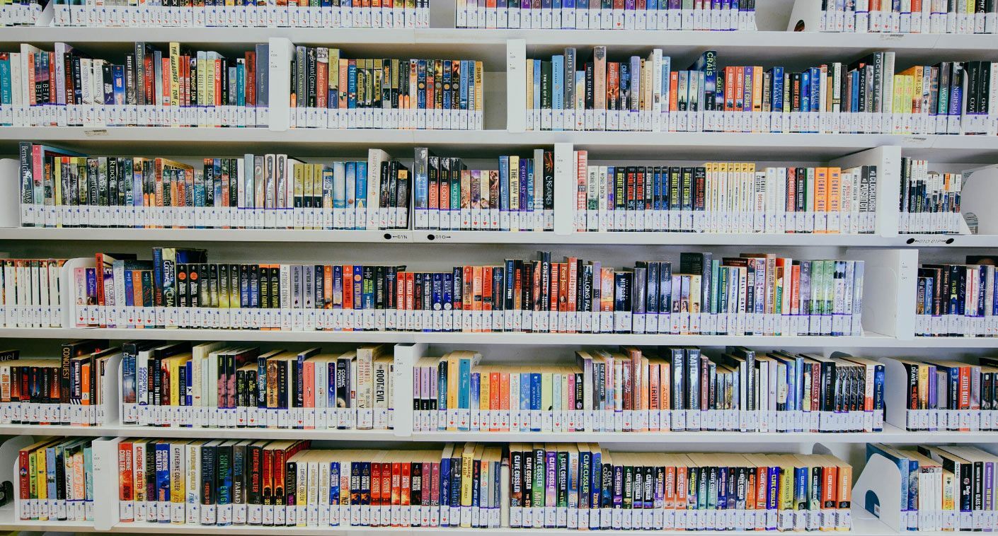 a bookshelf filled with lots of books including one titled ' a brief history of time '