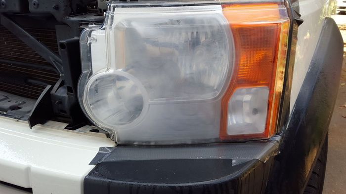 The headlight of a land rover discovery is missing.