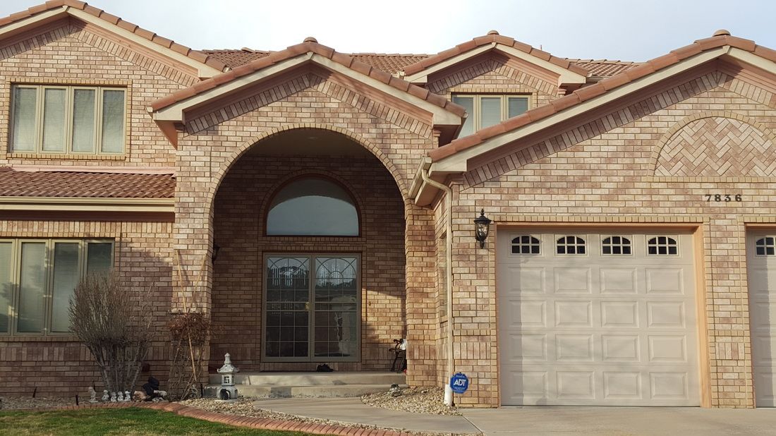 A large brick house with a white garage door