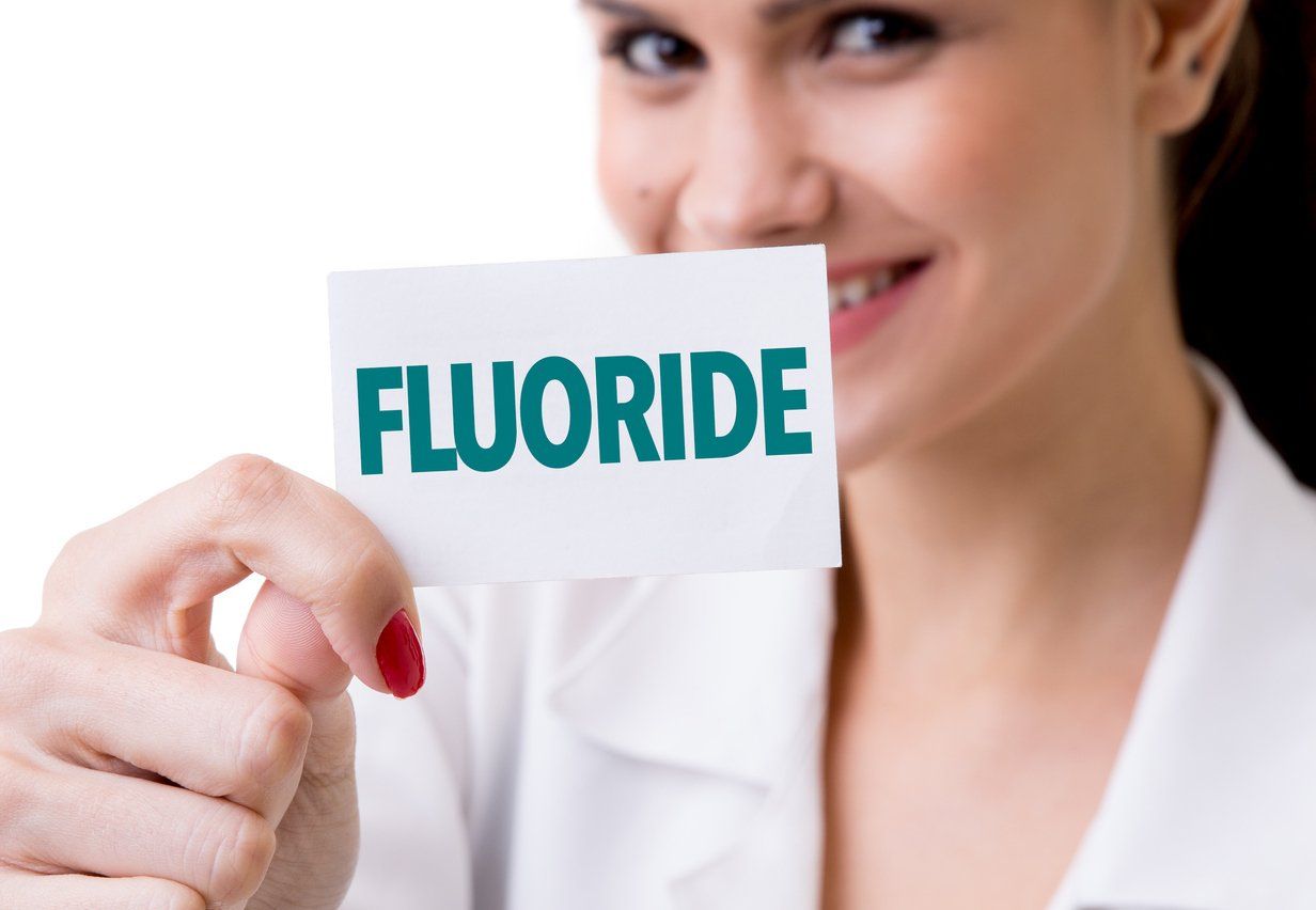 woman holding up flouride sign