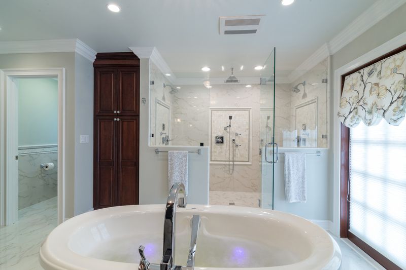 A bathroom with a bathtub and a walk in shower.